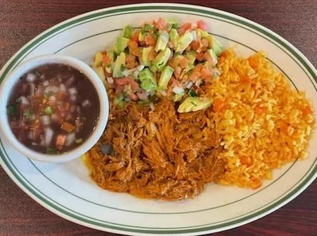 Cochinita pibil with Mexican rice, pico de gallo with avocado and frijoles de la olla, served at Julia&rsquo;s Mexican Restaurant