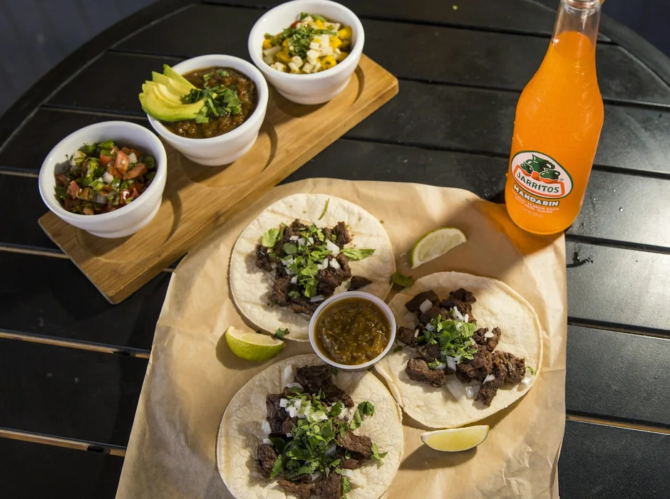 Street tacos with beef fajita, diced onion and cilantro, served with salsas
