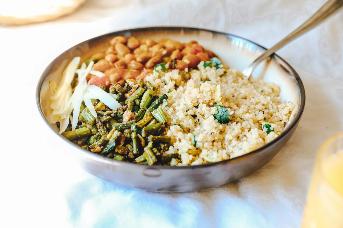 A bowl holding rice, beans and cooked vegetables together