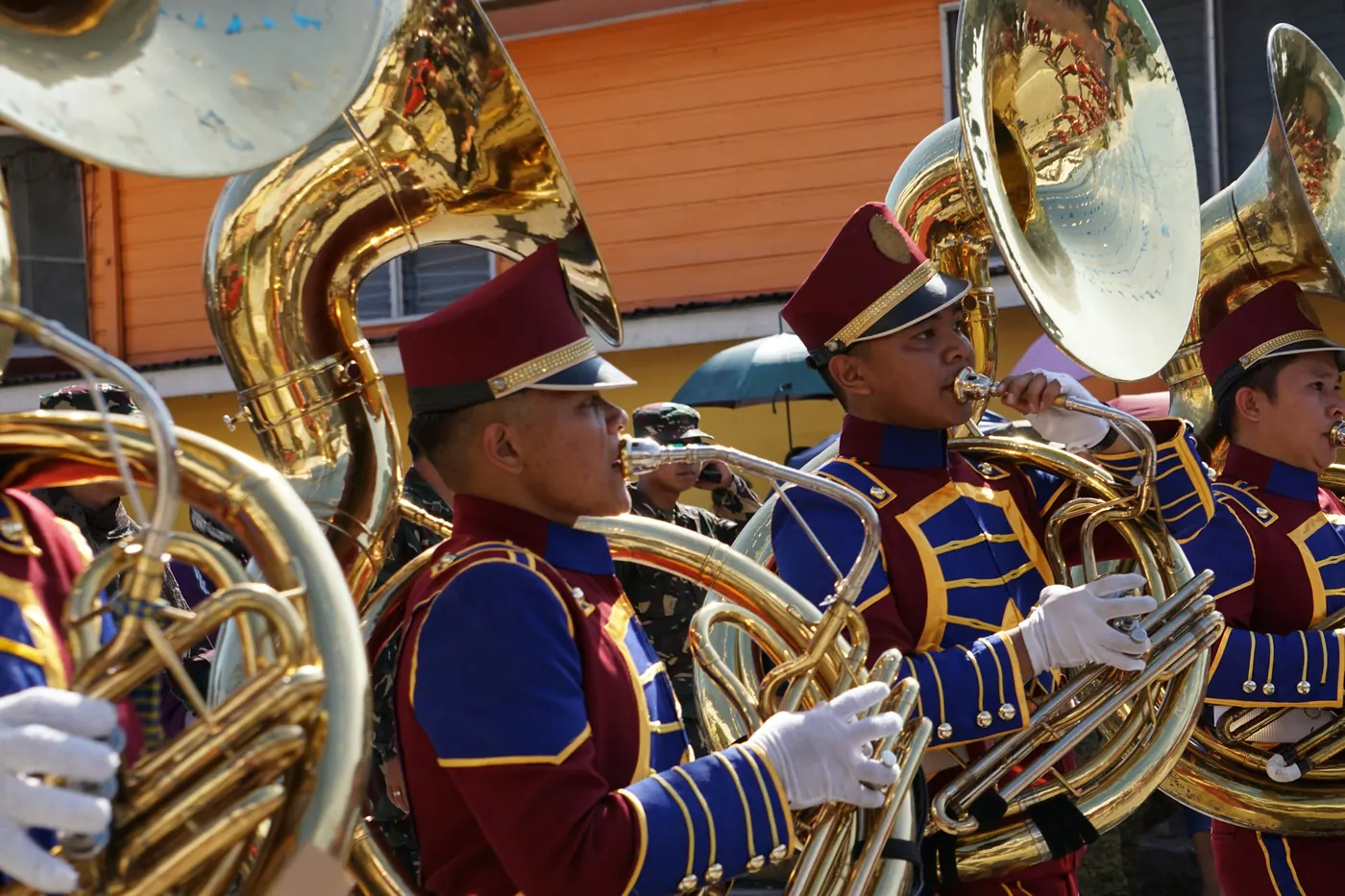 A brass band in formal uniform playing in a procession