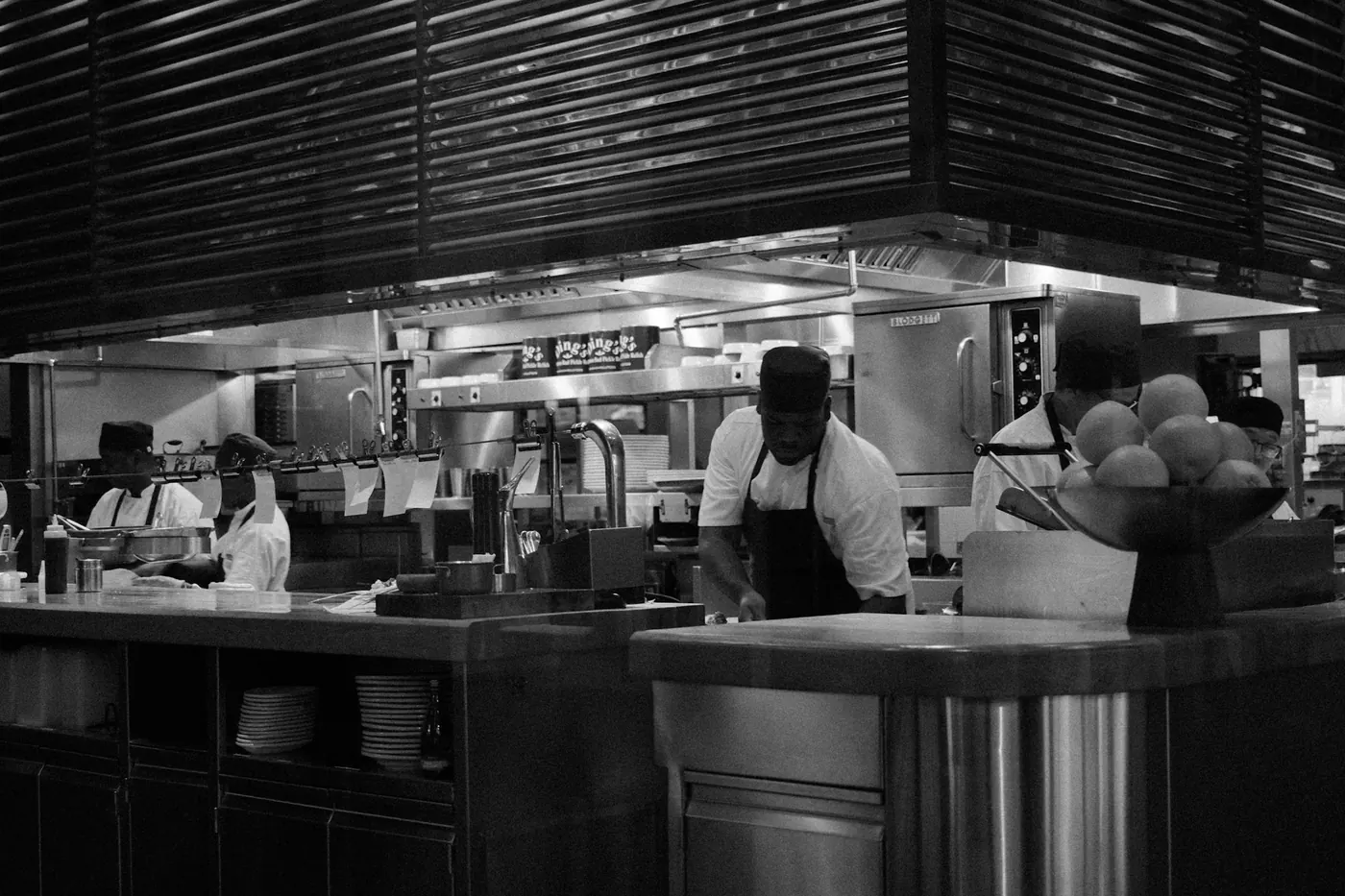 A busy professional kitchen with cooks working at stations