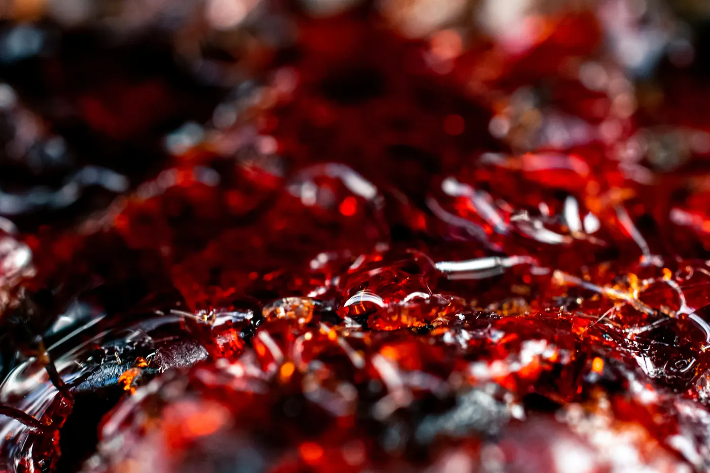 A dark red liquid simmering and bubbling