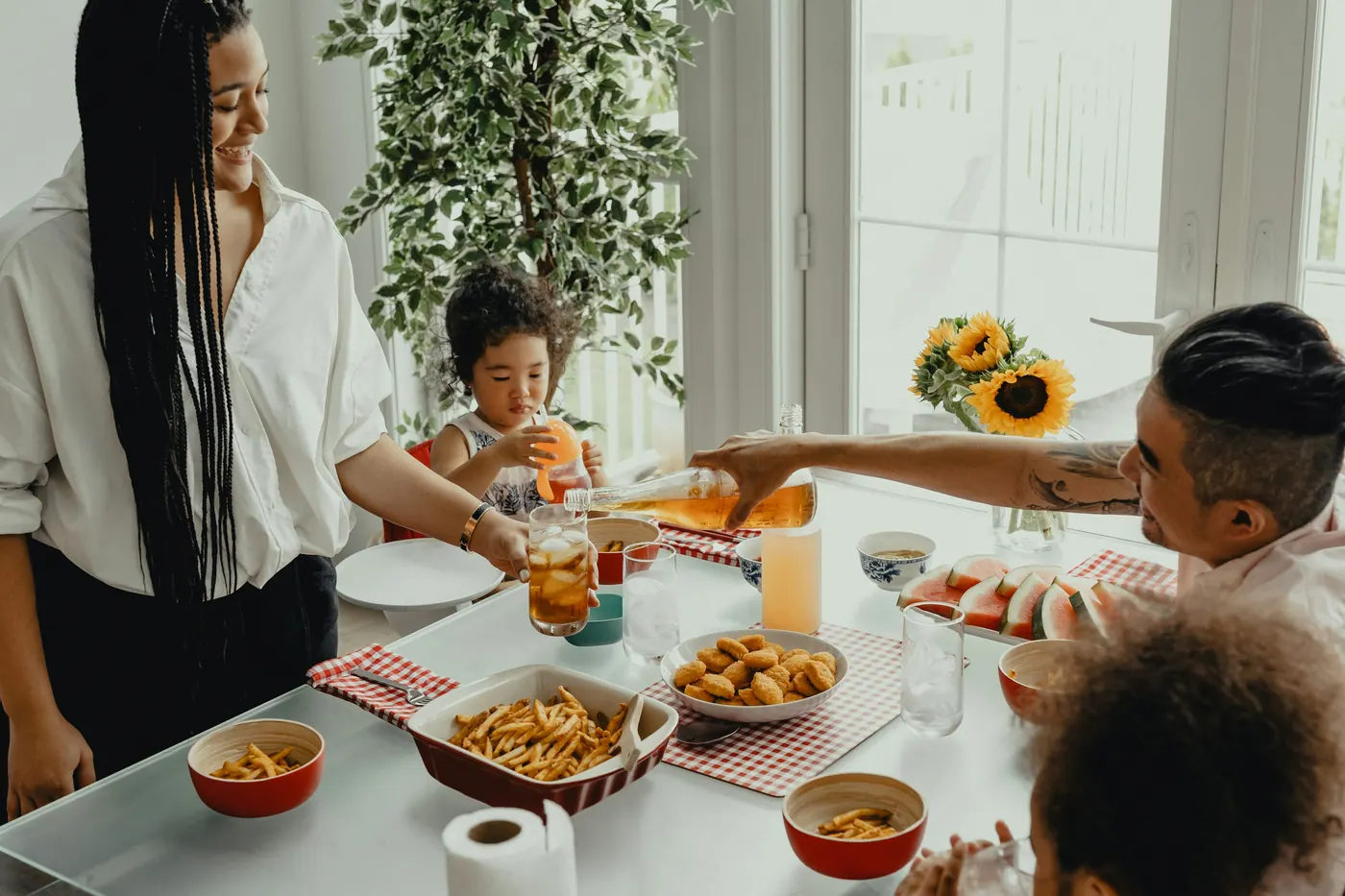 A family sharing a meal around a table set with dishes