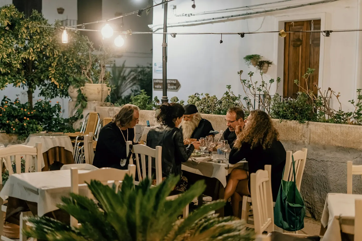 A group eating together at long tables outdoors