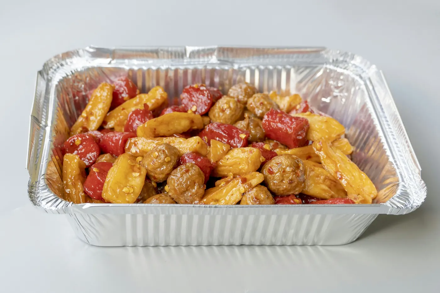 A foil takeout tray filled with cooked food