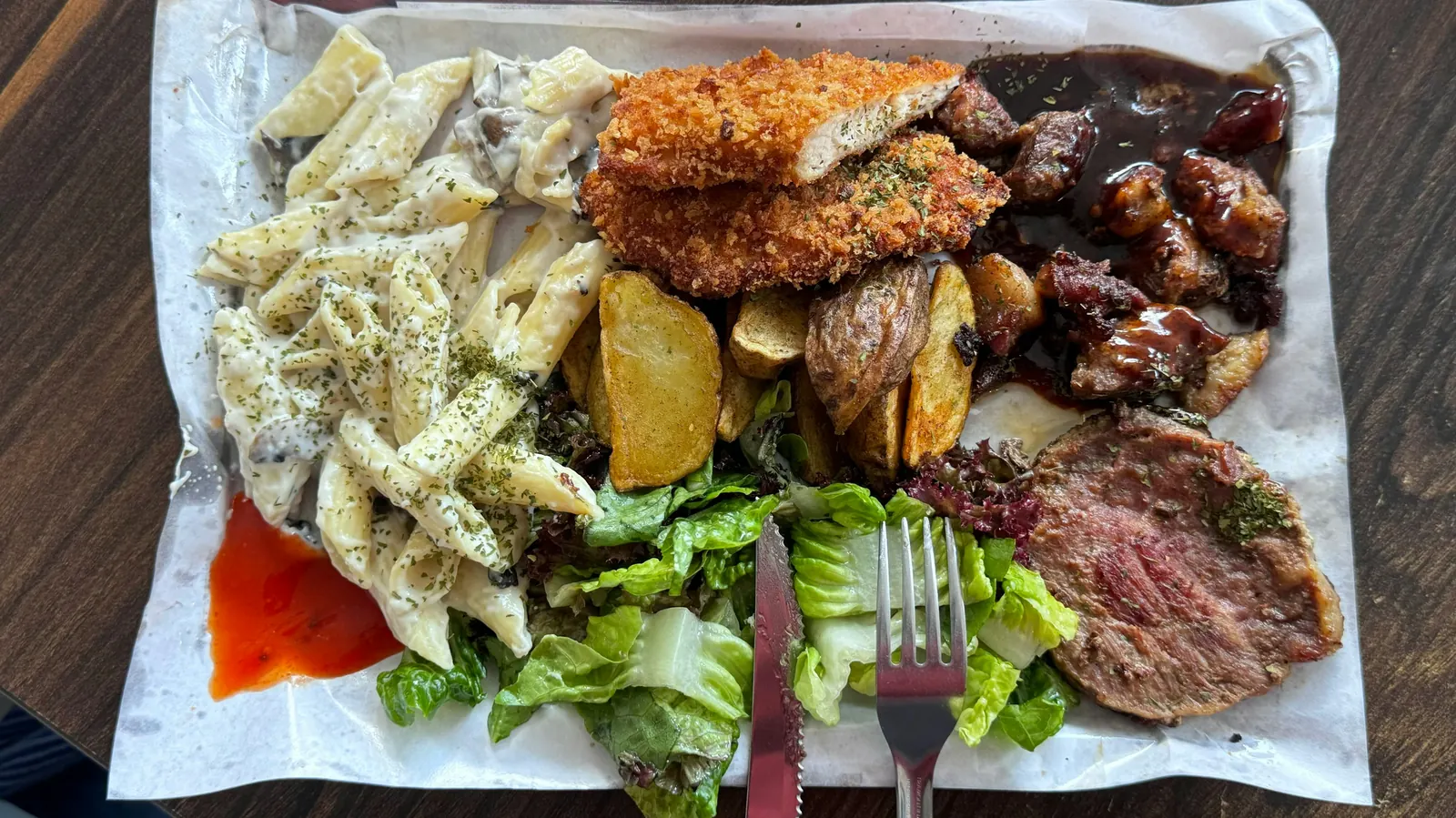 A large platter crowded with several different cooked dishes