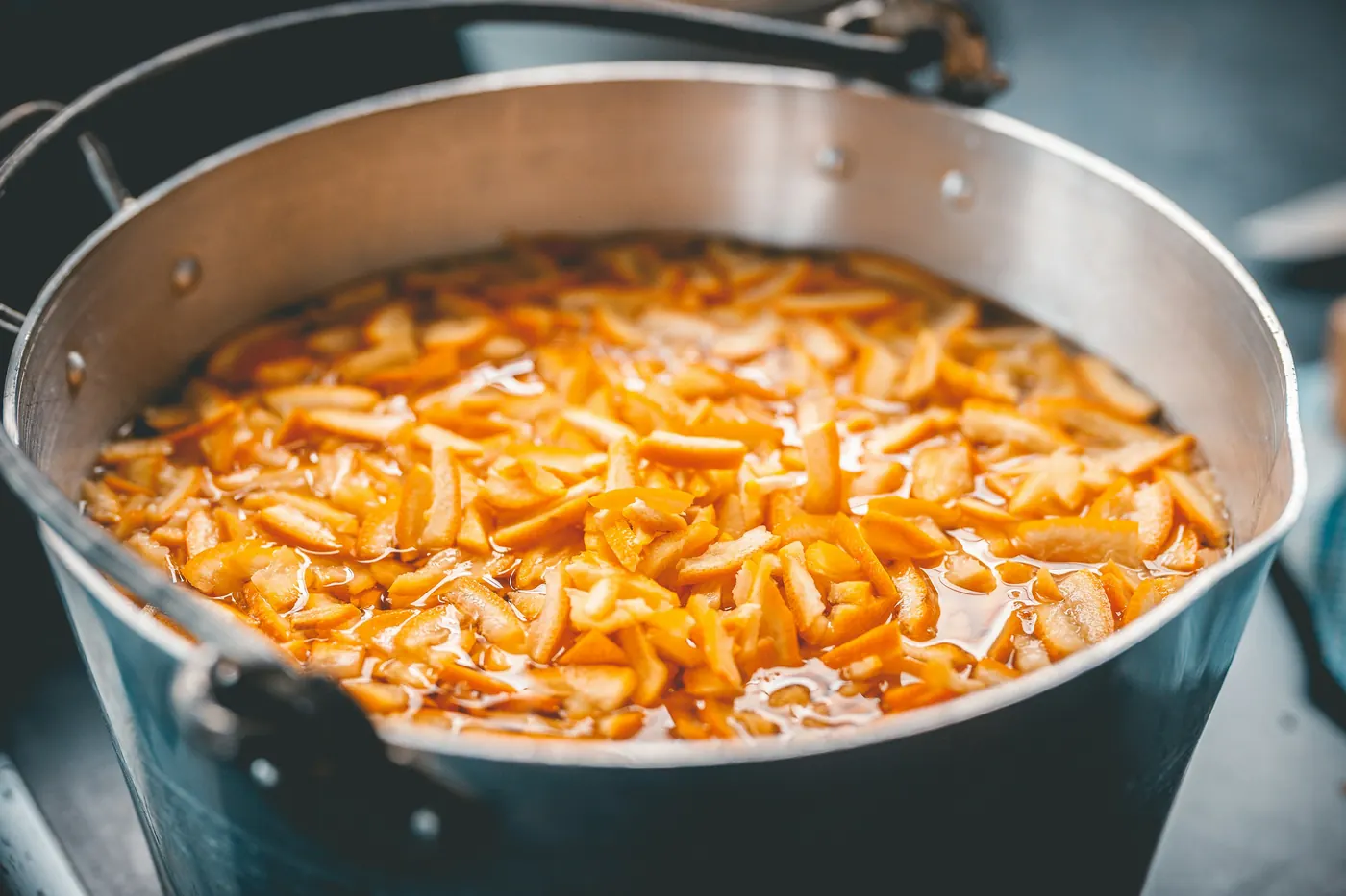 A large pot of orange rice being cooked in quantity