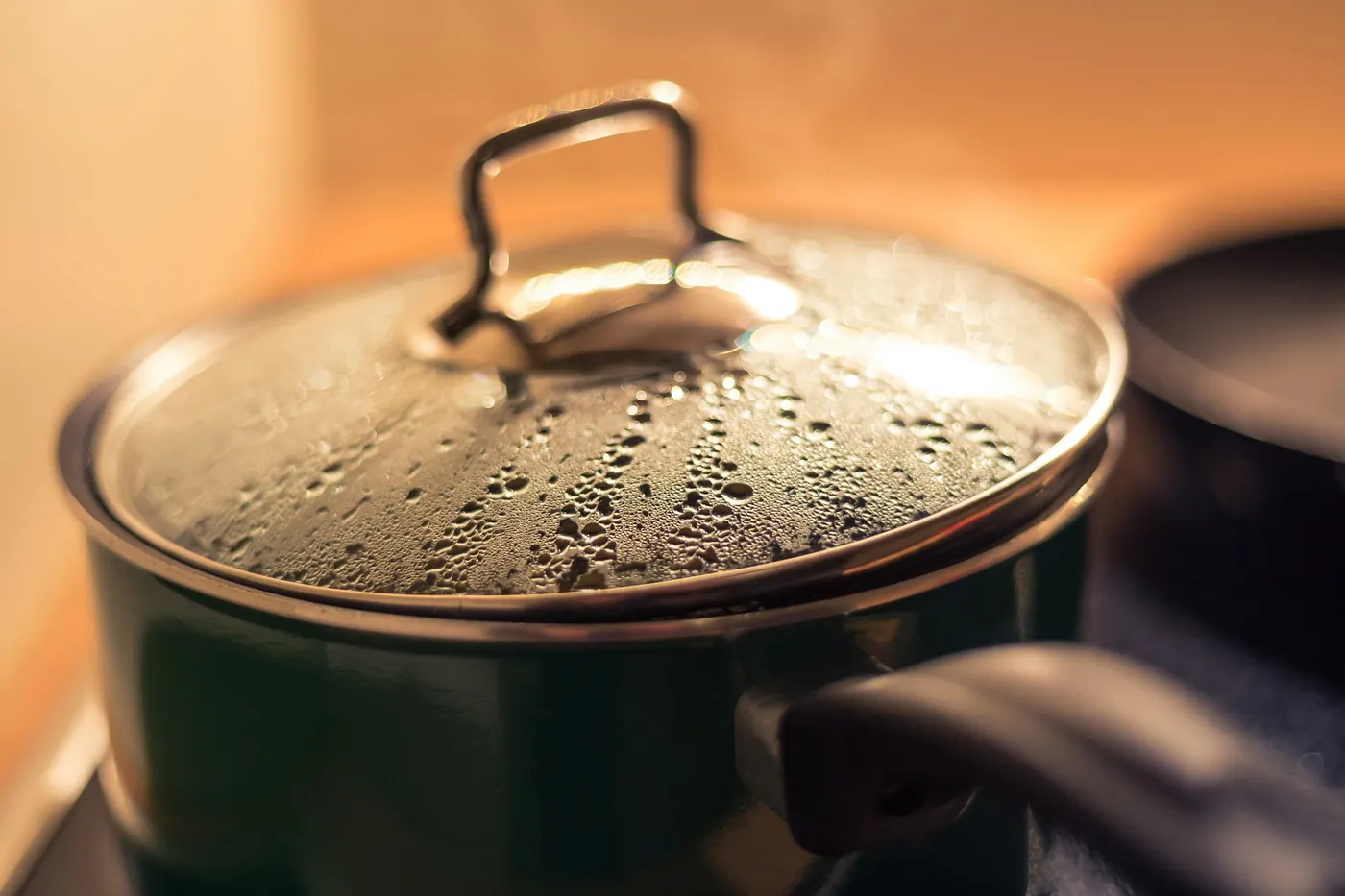 A large lidded pot steaming on a stove