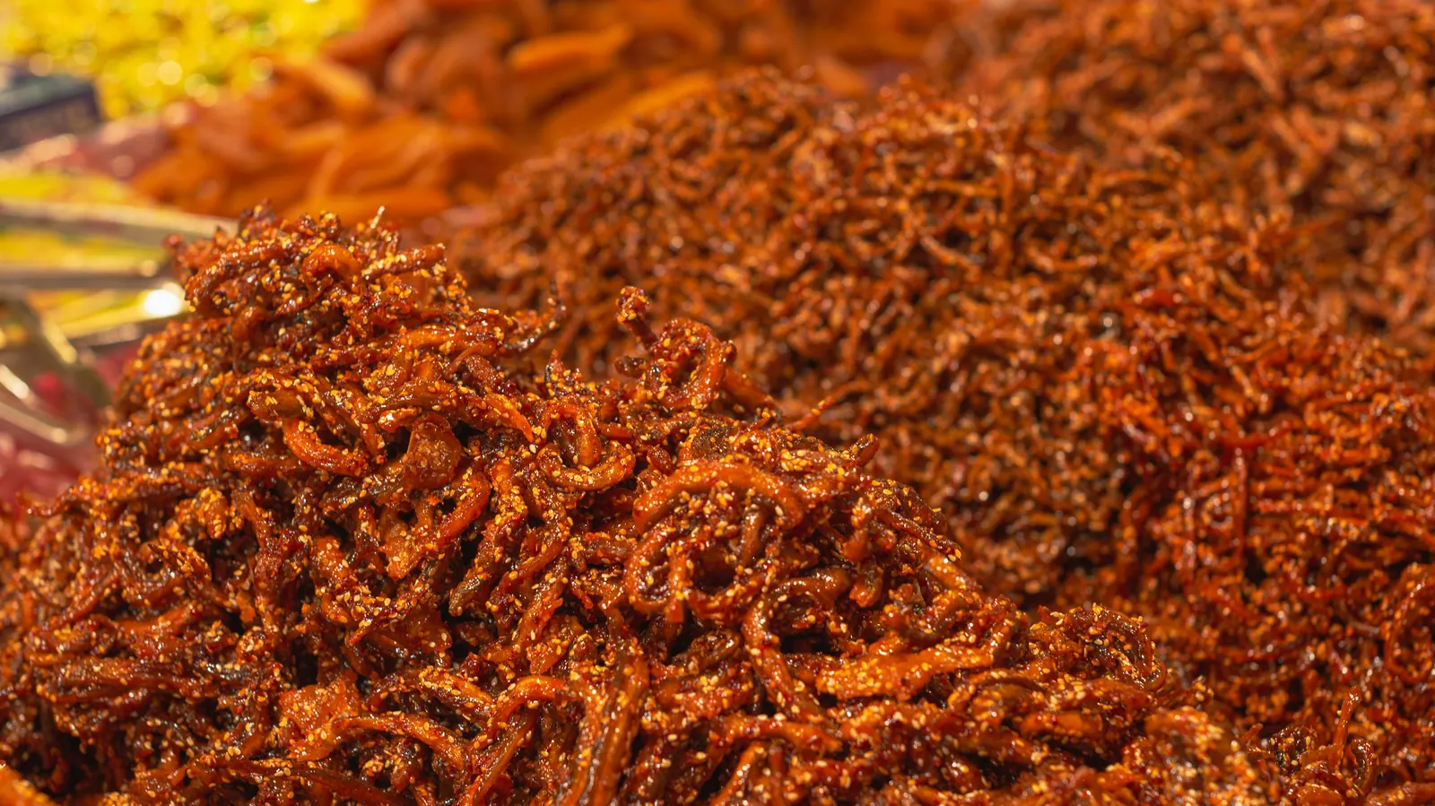 A large mound of deep orange-red shredded pork