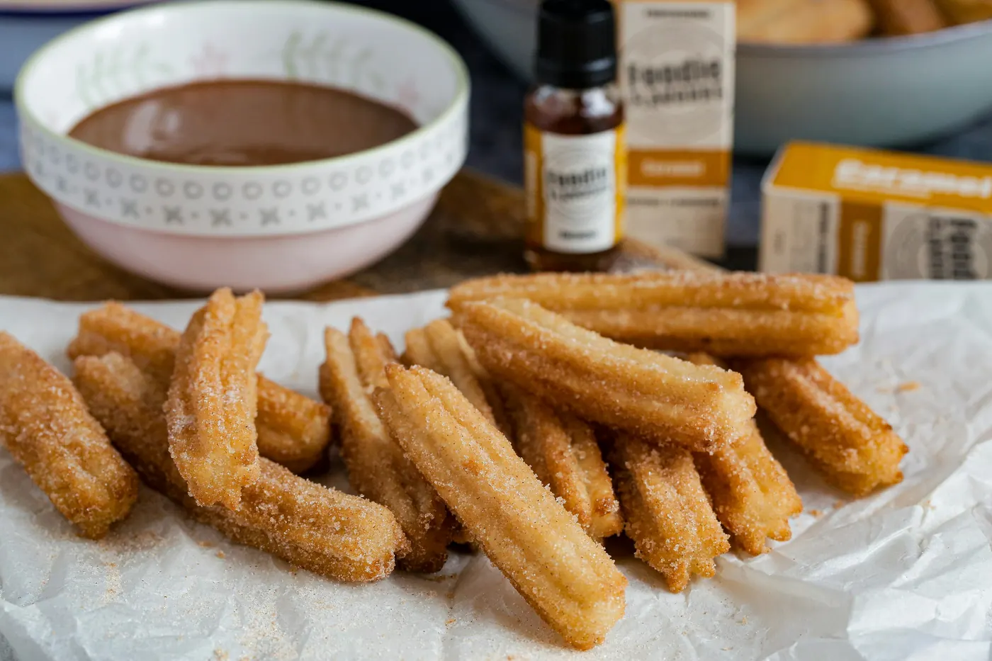 A heap of freshly fried churros dusted with sugar