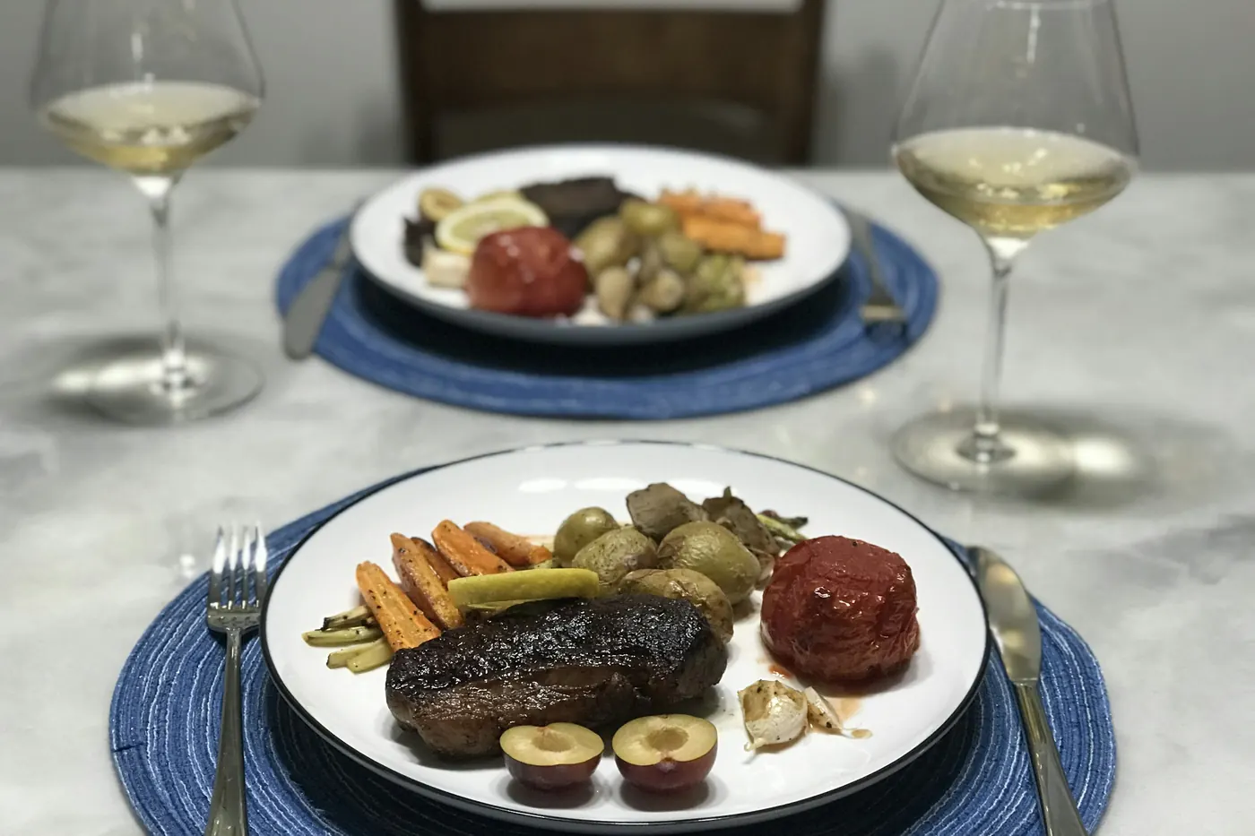 A plated meal with meat and vegetables on a restaurant table