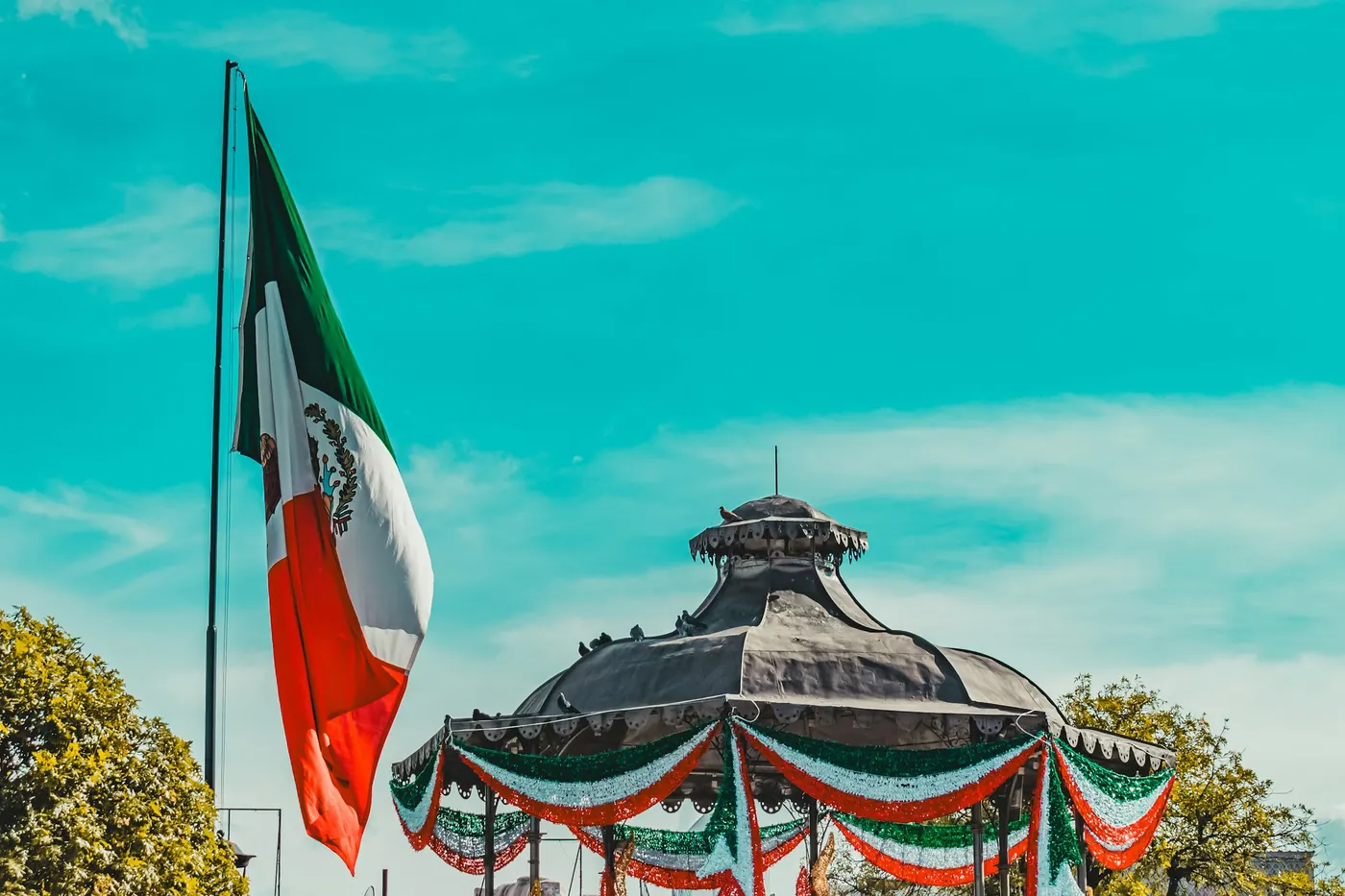 A town plaza bandstand decorated with flags and bunting