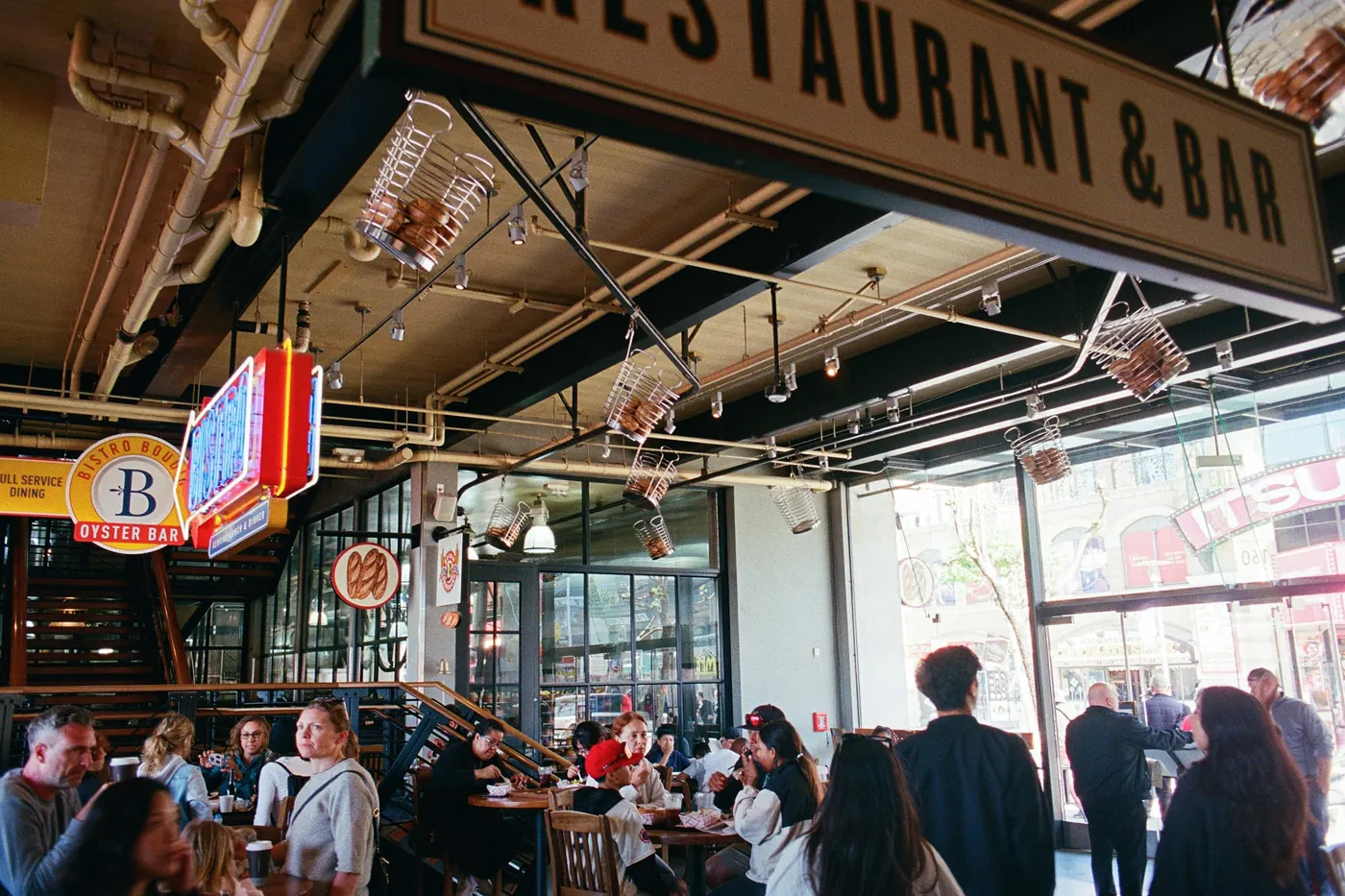 The interior of a restaurant and bar with people seated at tables