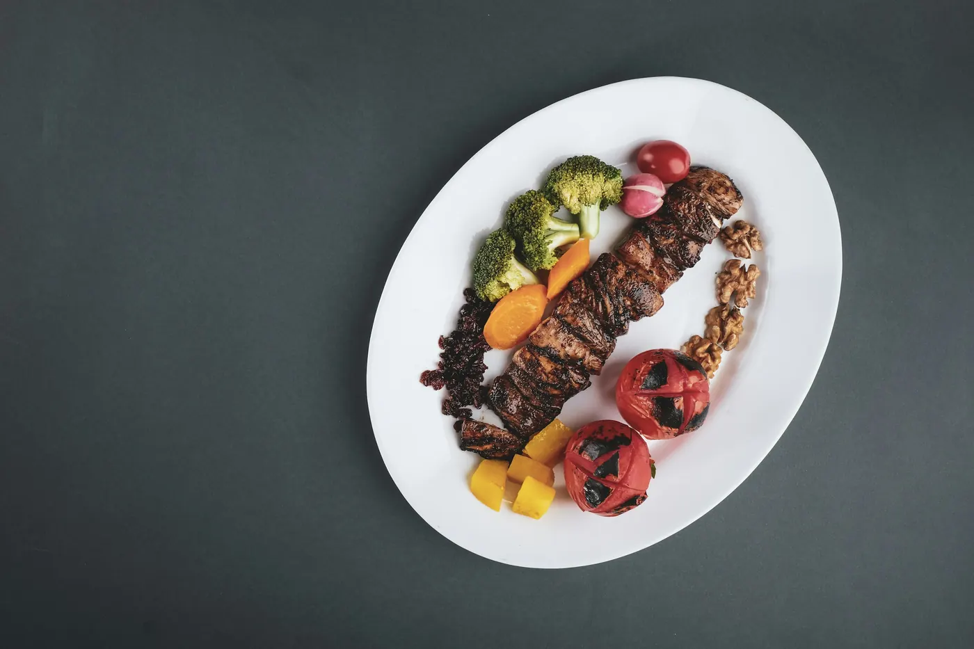 A modest portion of food arranged on a large white plate