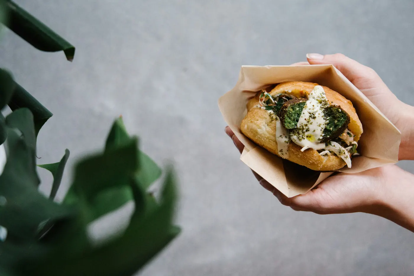A filled taco held in a folded paper wrapper