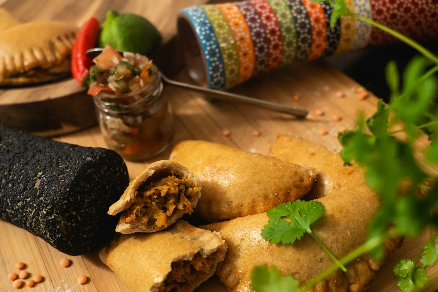 An empanada broken open to show the seasoned filling inside