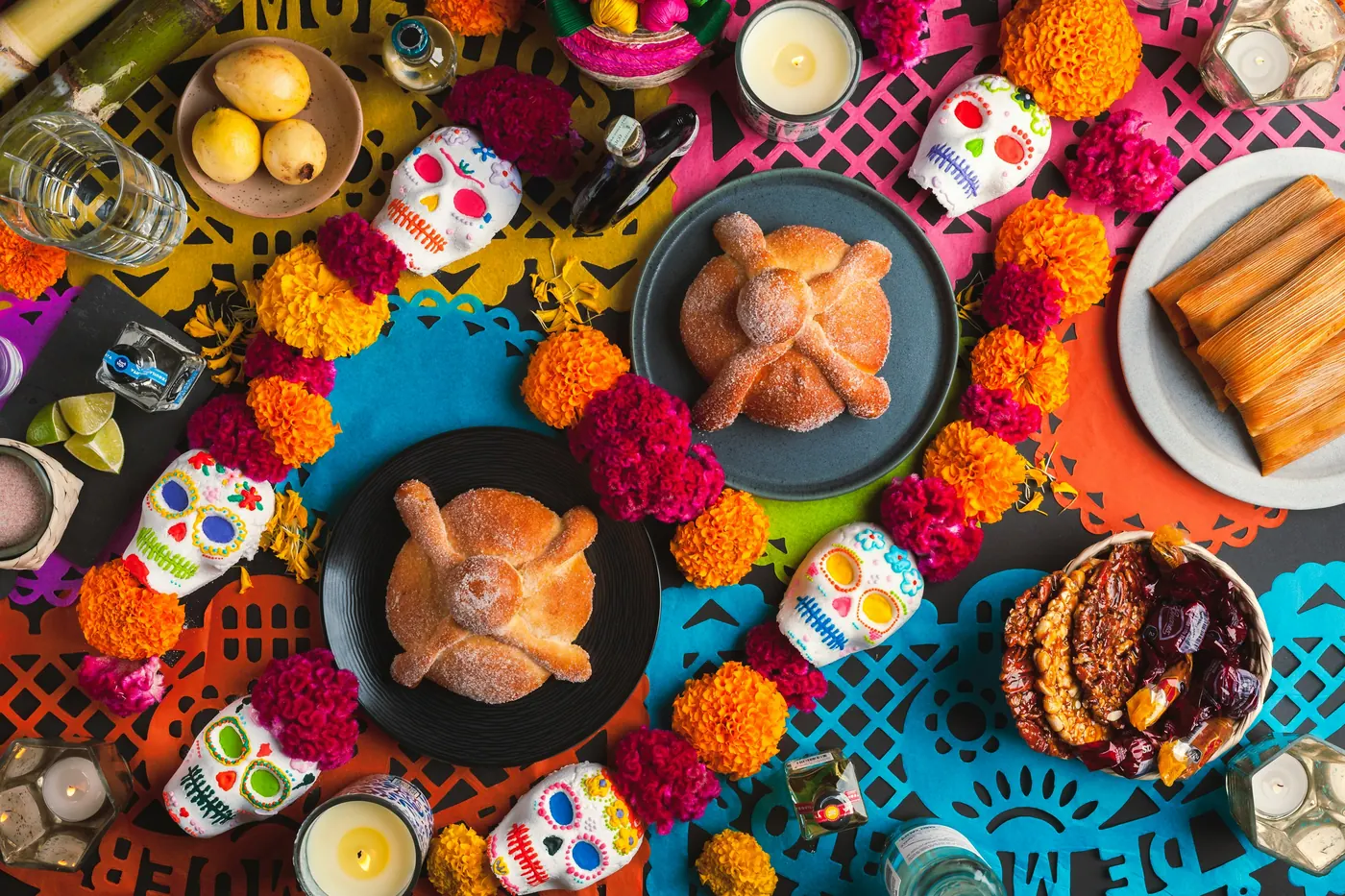 An overhead view of many small dishes and marigolds laid out together