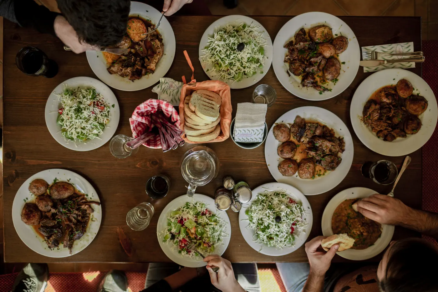 An overhead view of a table covered with shared dishes
