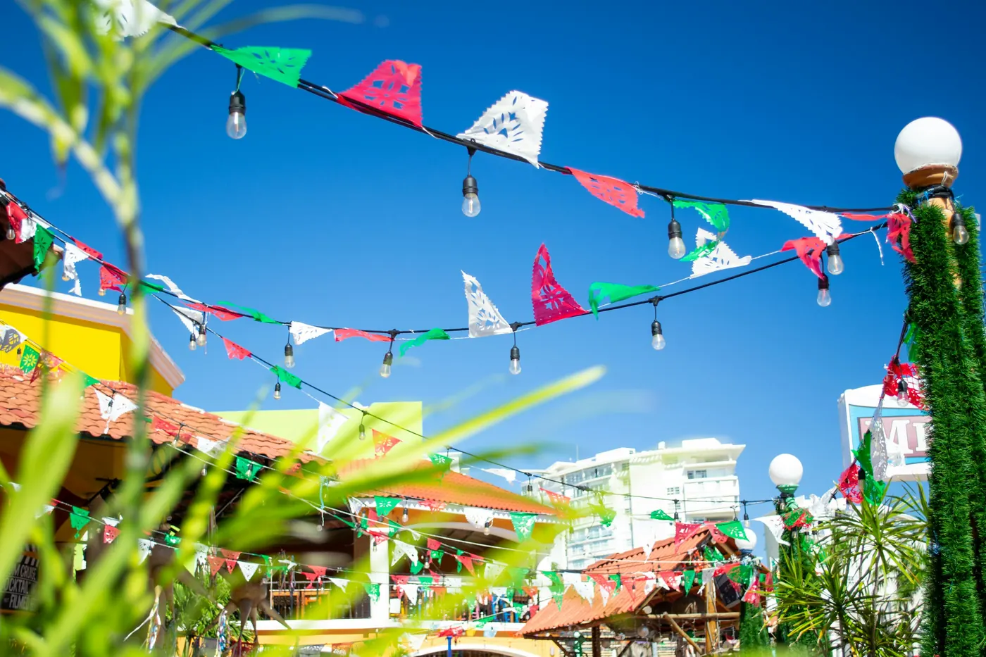 Strings of small flags and bunting strung above a street