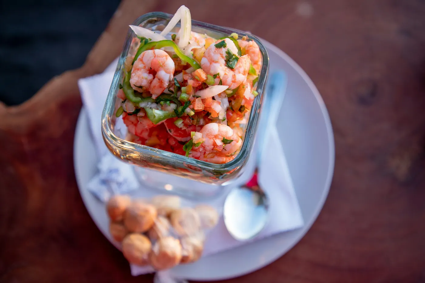 Ceviche of shrimp and diced vegetables served in a small glass