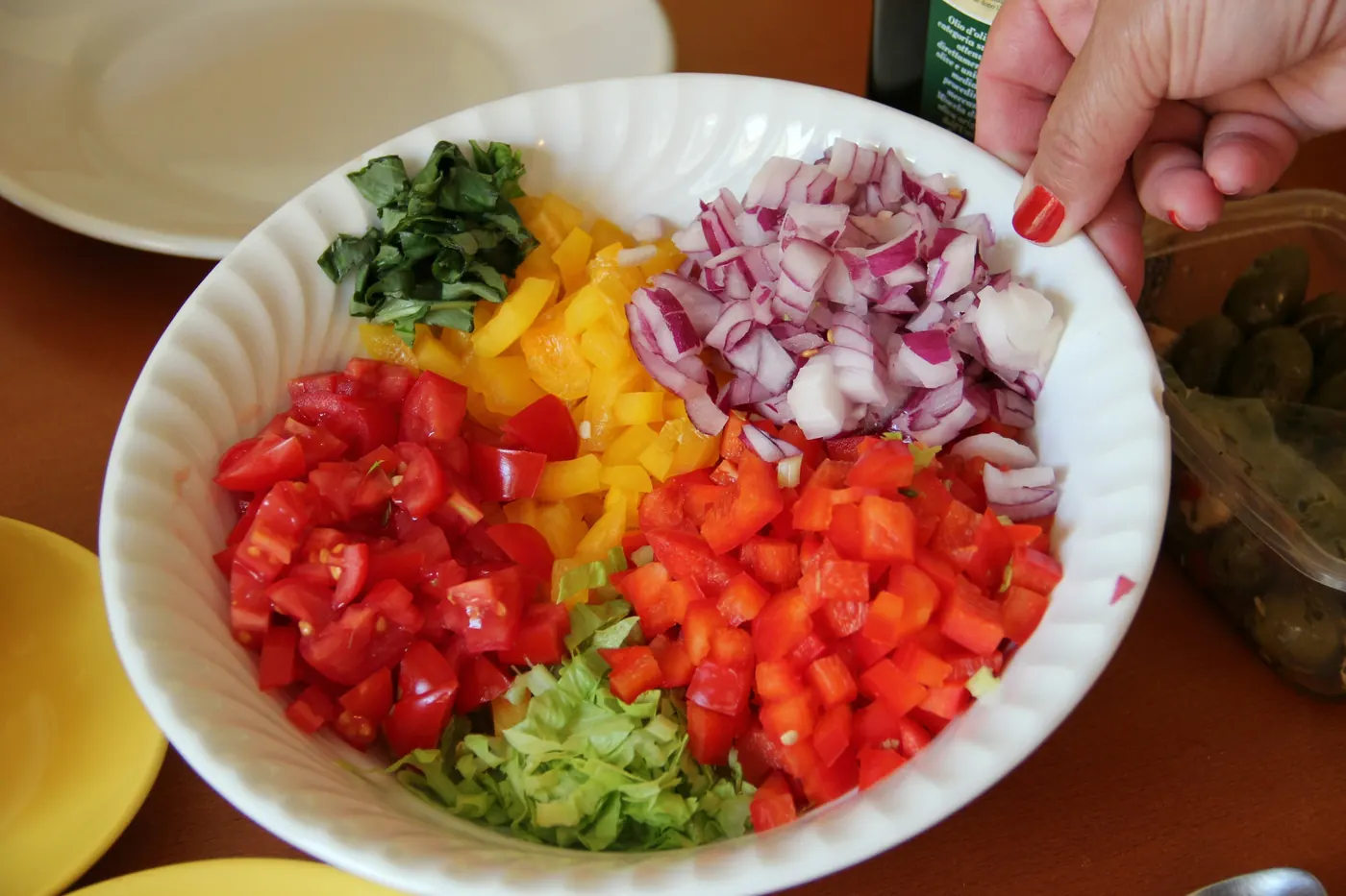 A dish of chopped tomato, onion, herbs and guacamole