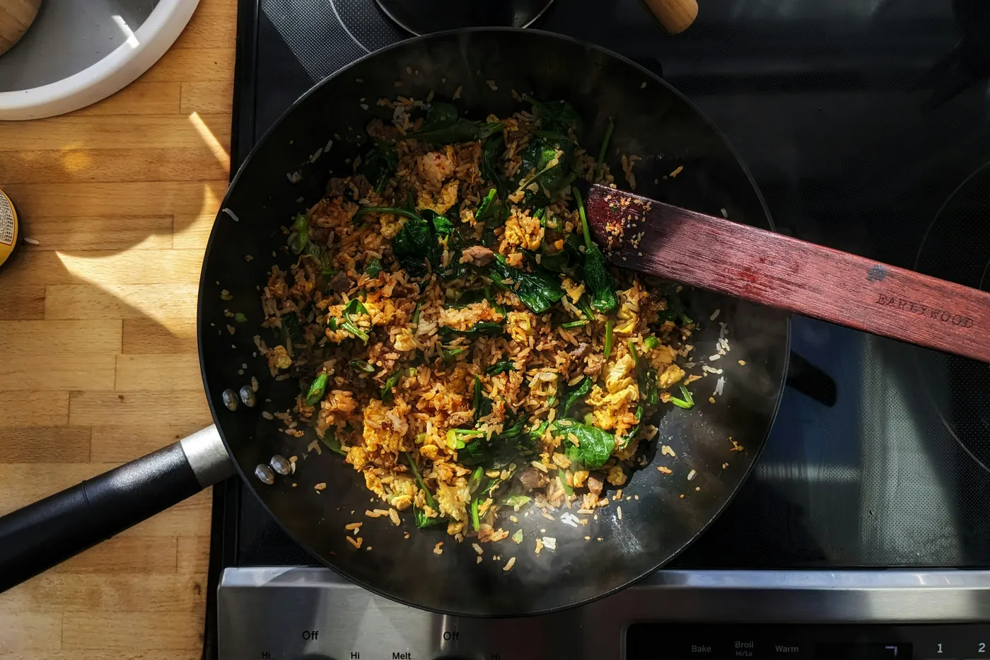 Chorizo and egg being stirred together in a dark pan