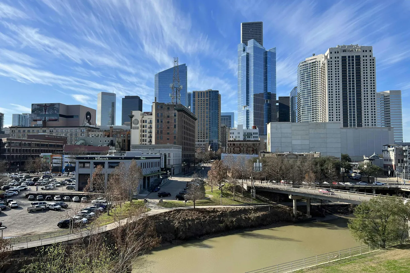Downtown Houston towers seen across a bayou and freeway