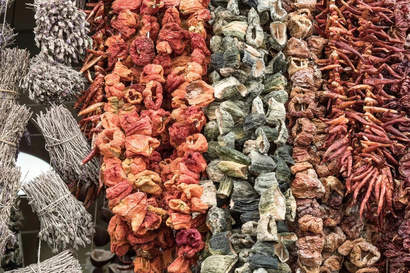 Long rows of dried chiles hanging in a market