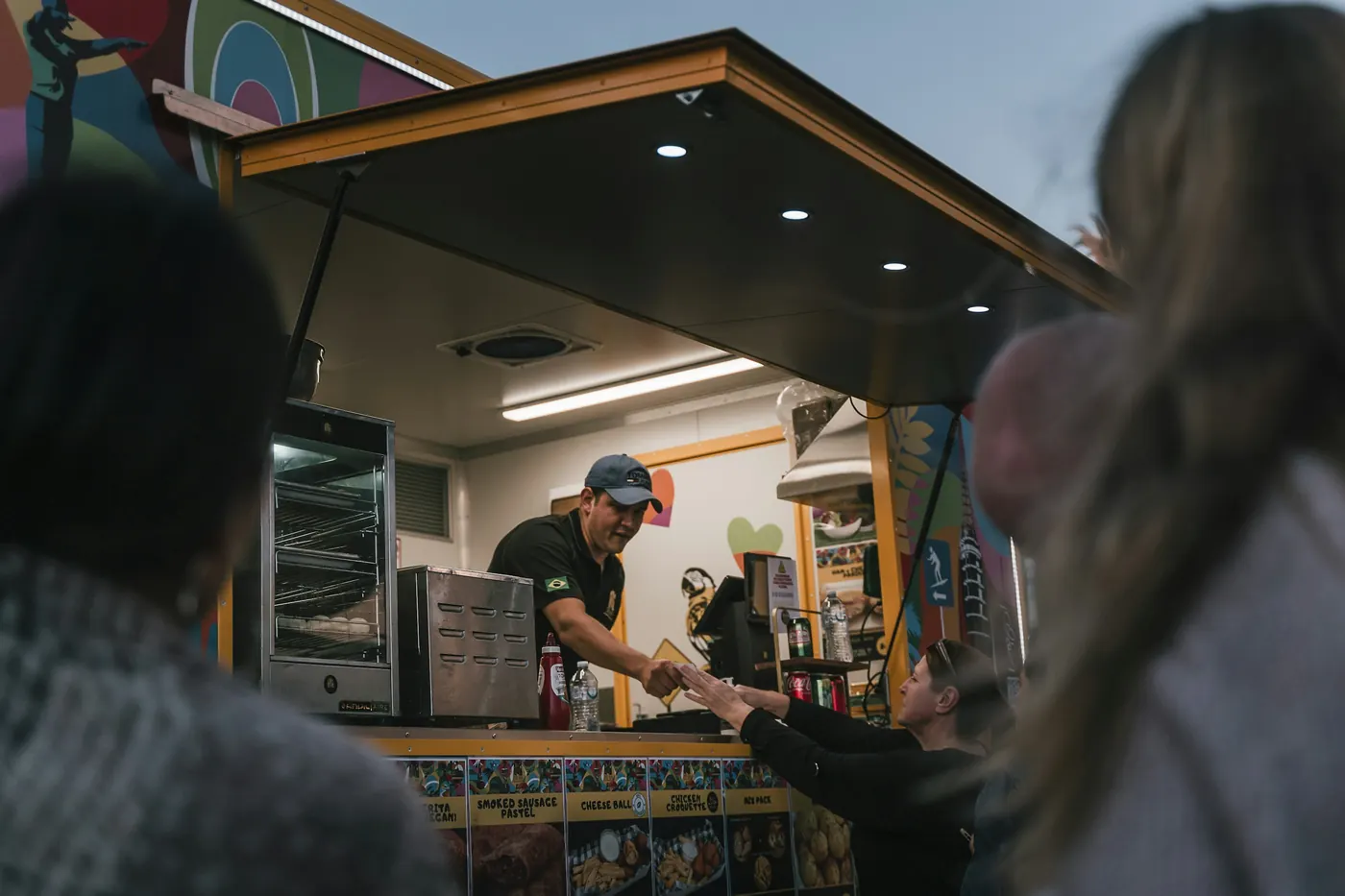 A plate of food being handed across a service counter