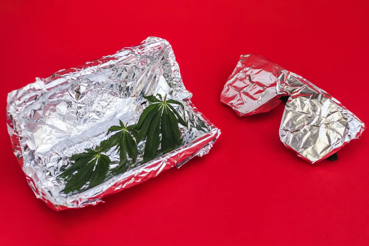 Several small parcels of food wrapped in aluminum foil