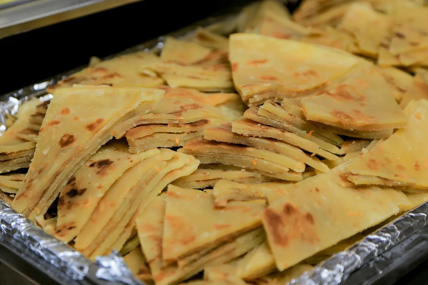 A tray piled with fried tortilla wedges
