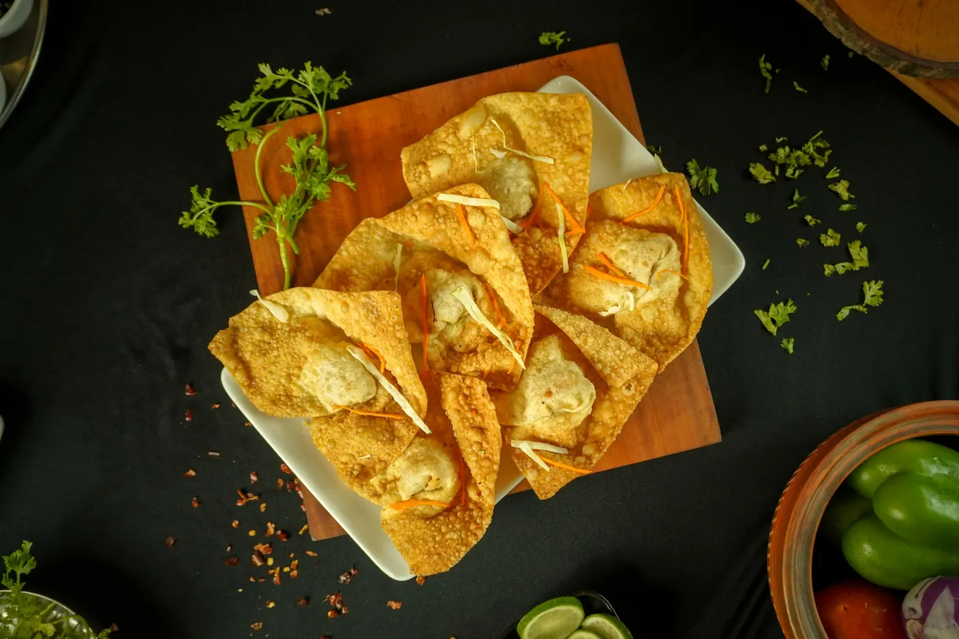 Golden fried tortilla rolls arranged on a dark surface