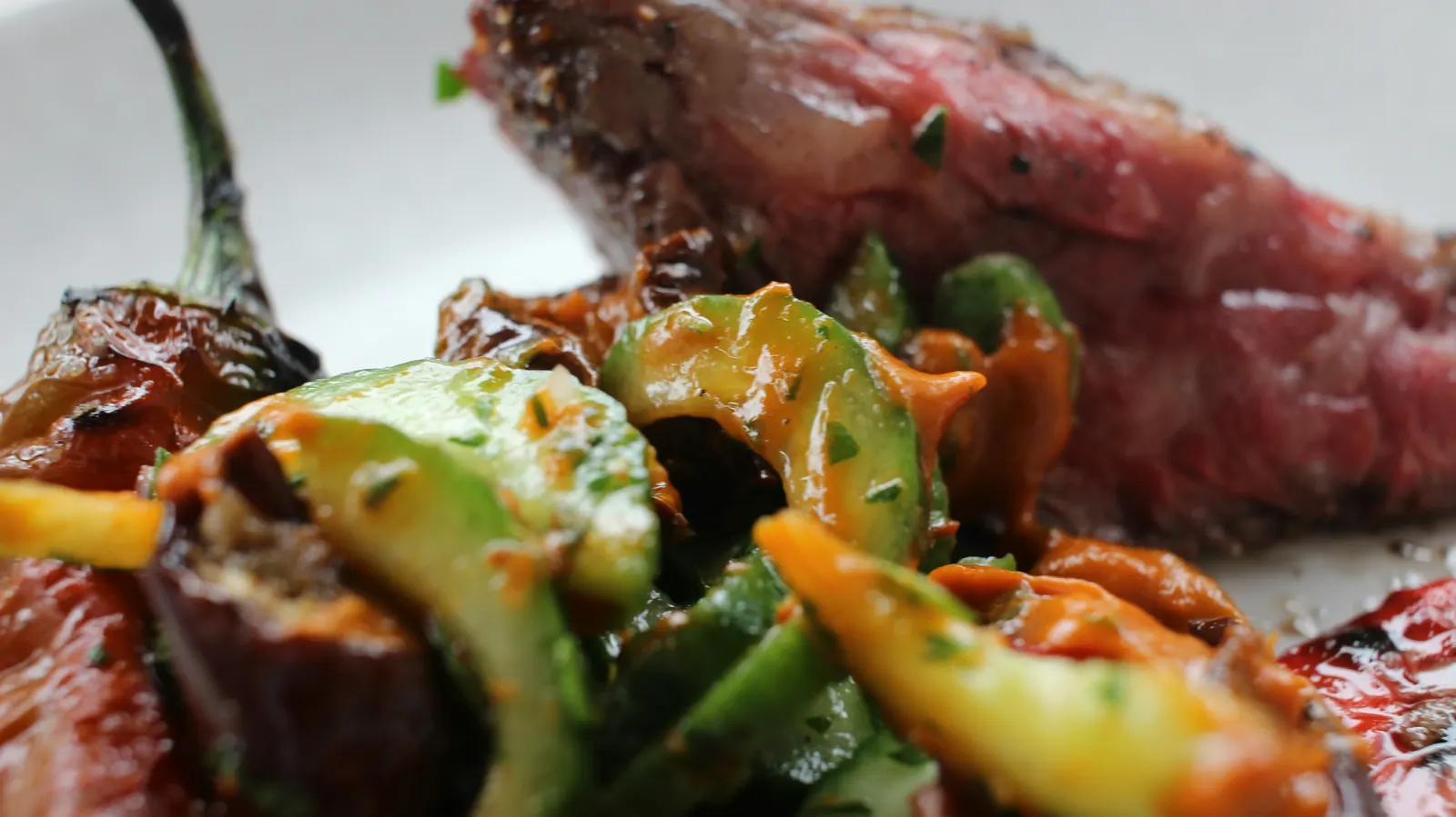 Sliced grilled beef with charred peppers
