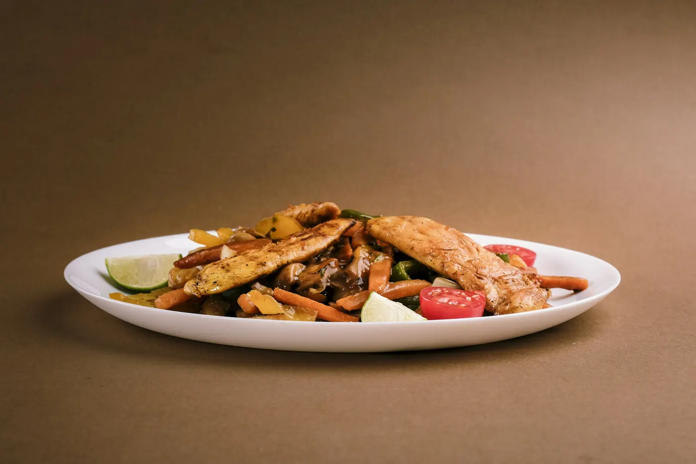 Strips of grilled chicken served plainly on a white plate