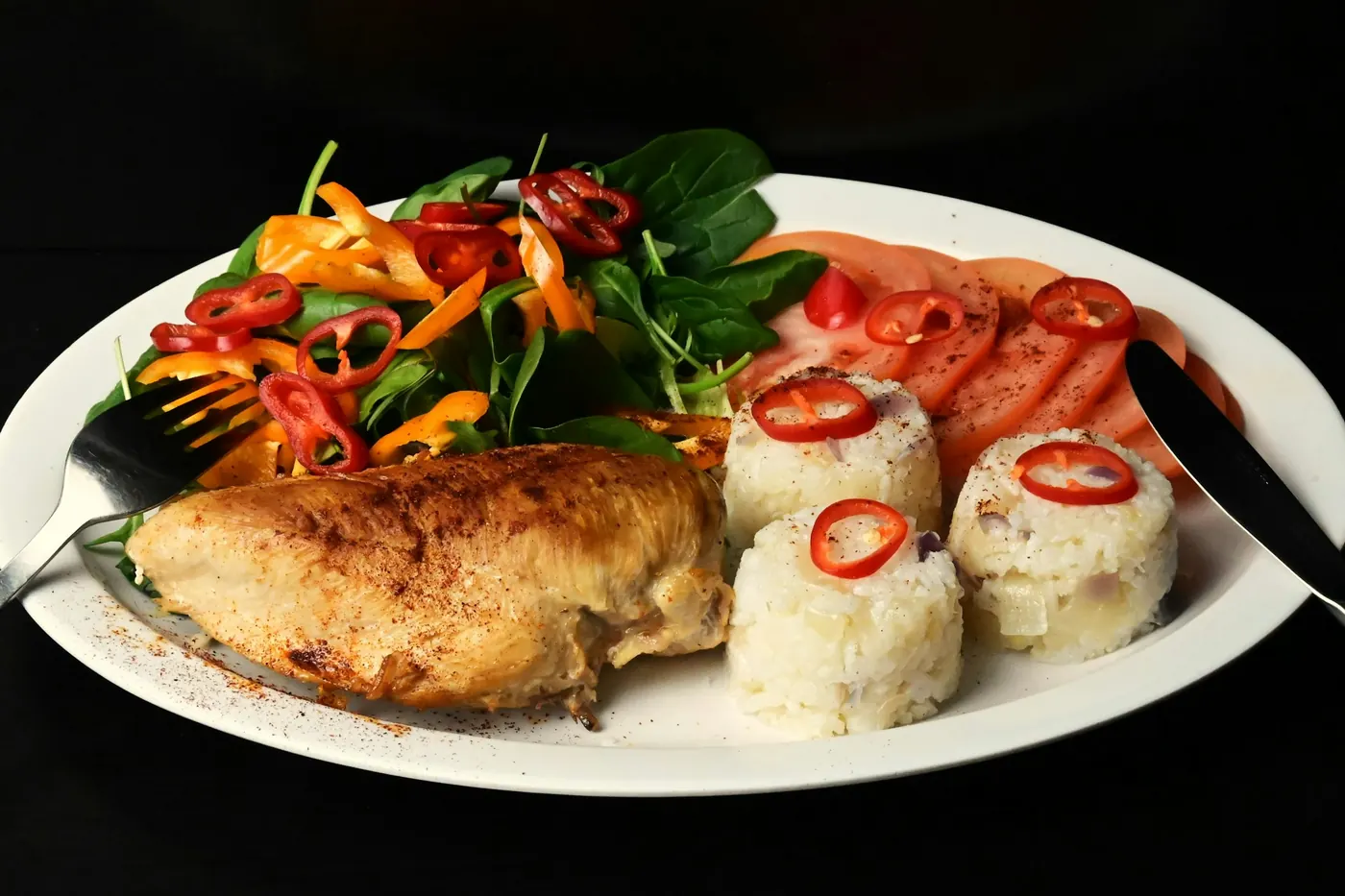 A grilled fish fillet plated with vegetables