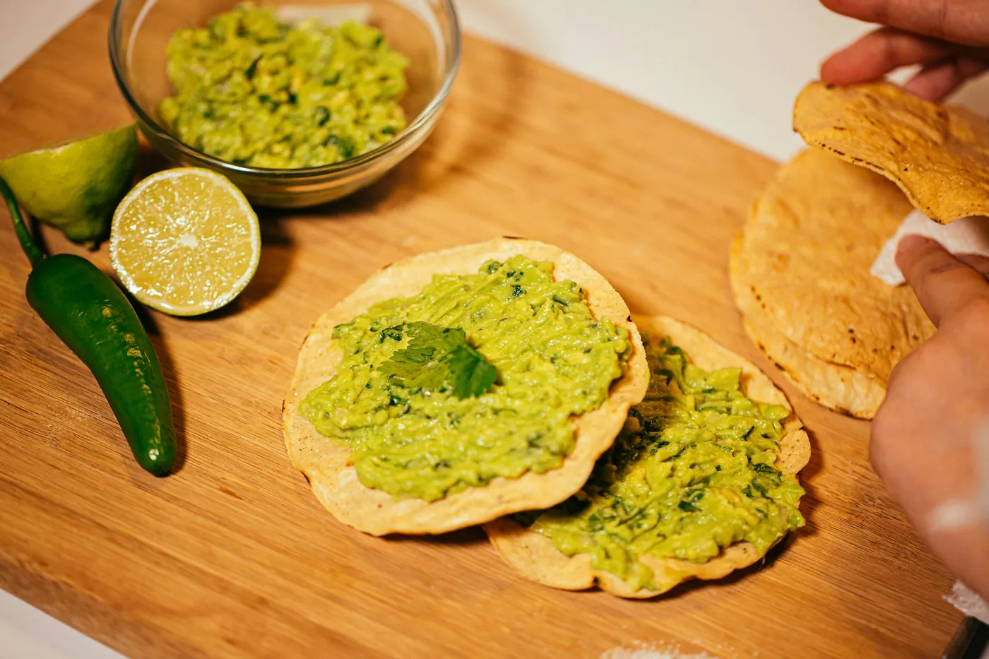 Masa cakes spread with green salsa and avocado