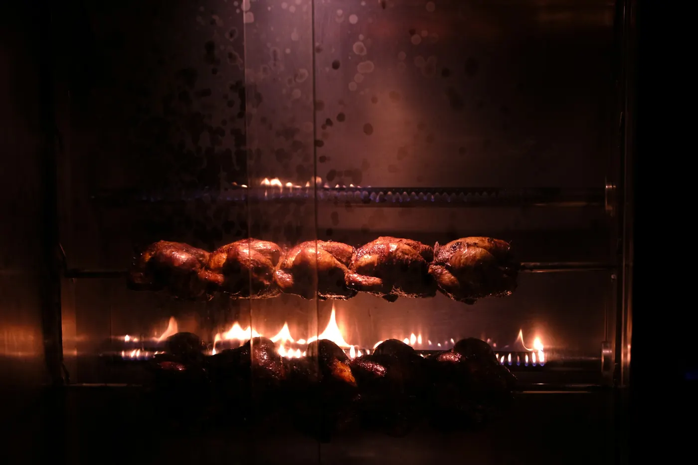 Meat cooking over glowing open coals