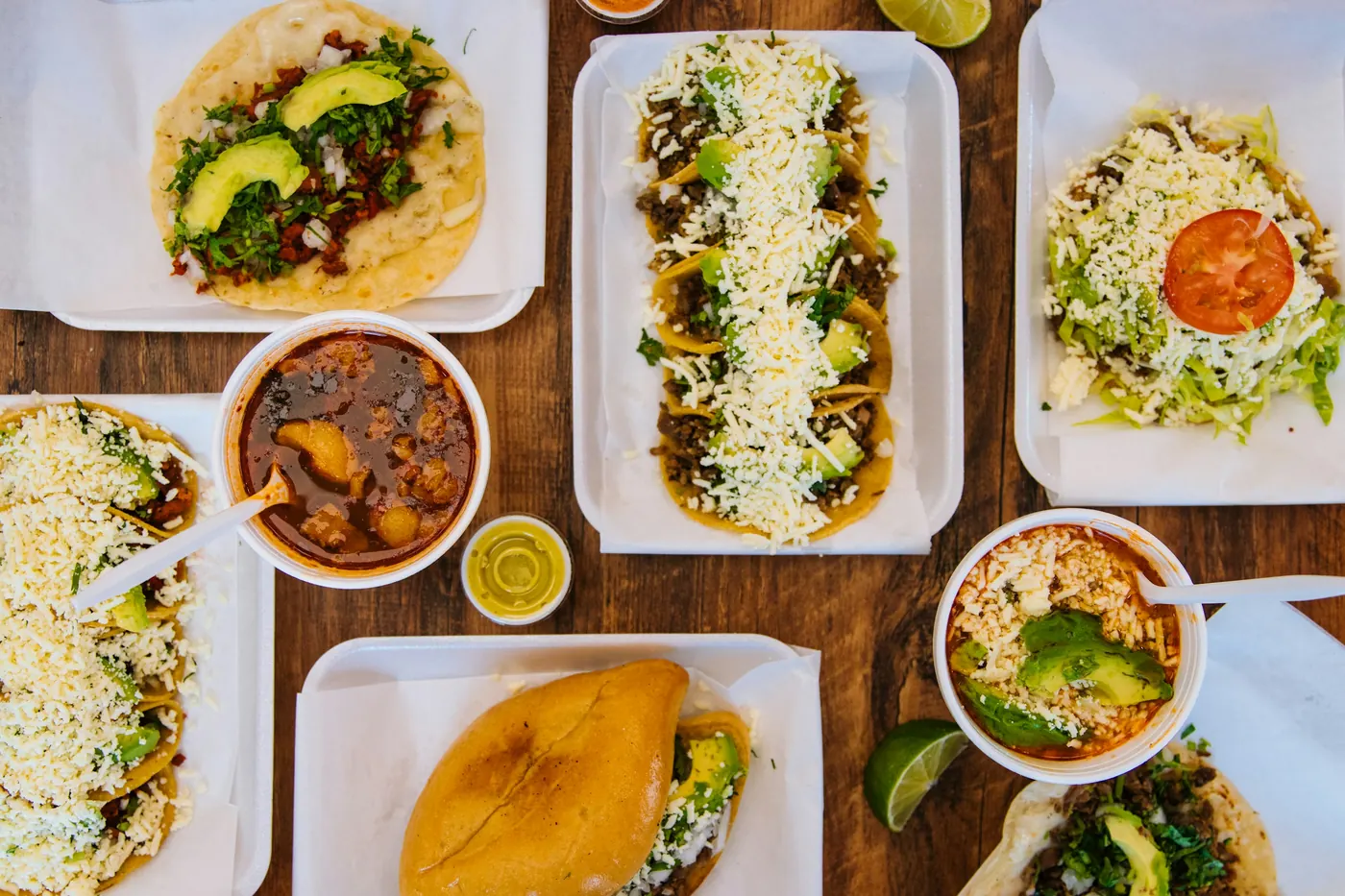 Several carefully plated modern Mexican dishes on white plates