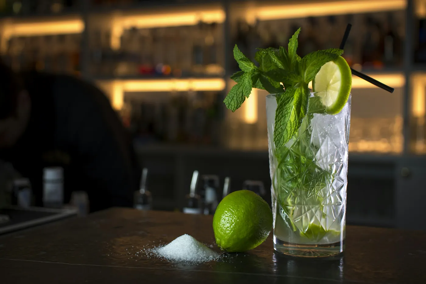 A mojito with fresh mint and lime in a tall glass