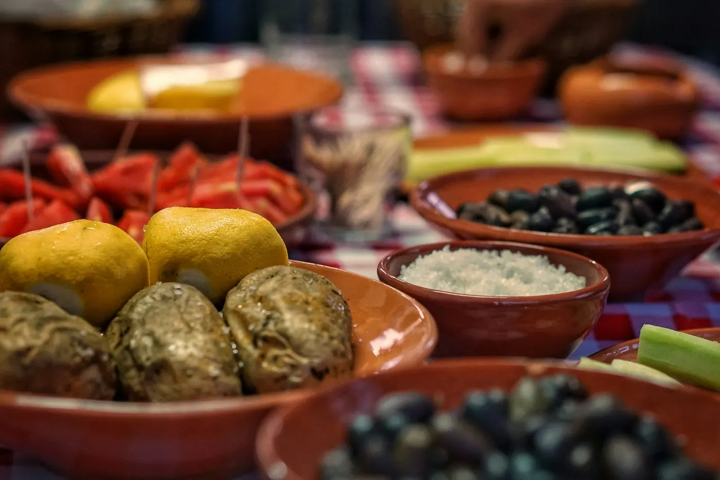 Clay bowls of olives, croquettes and bread on a table
