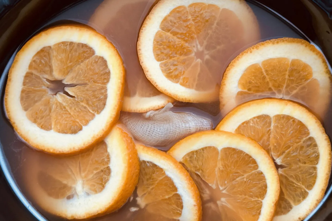 Slices of orange floating on the surface of a hot punch