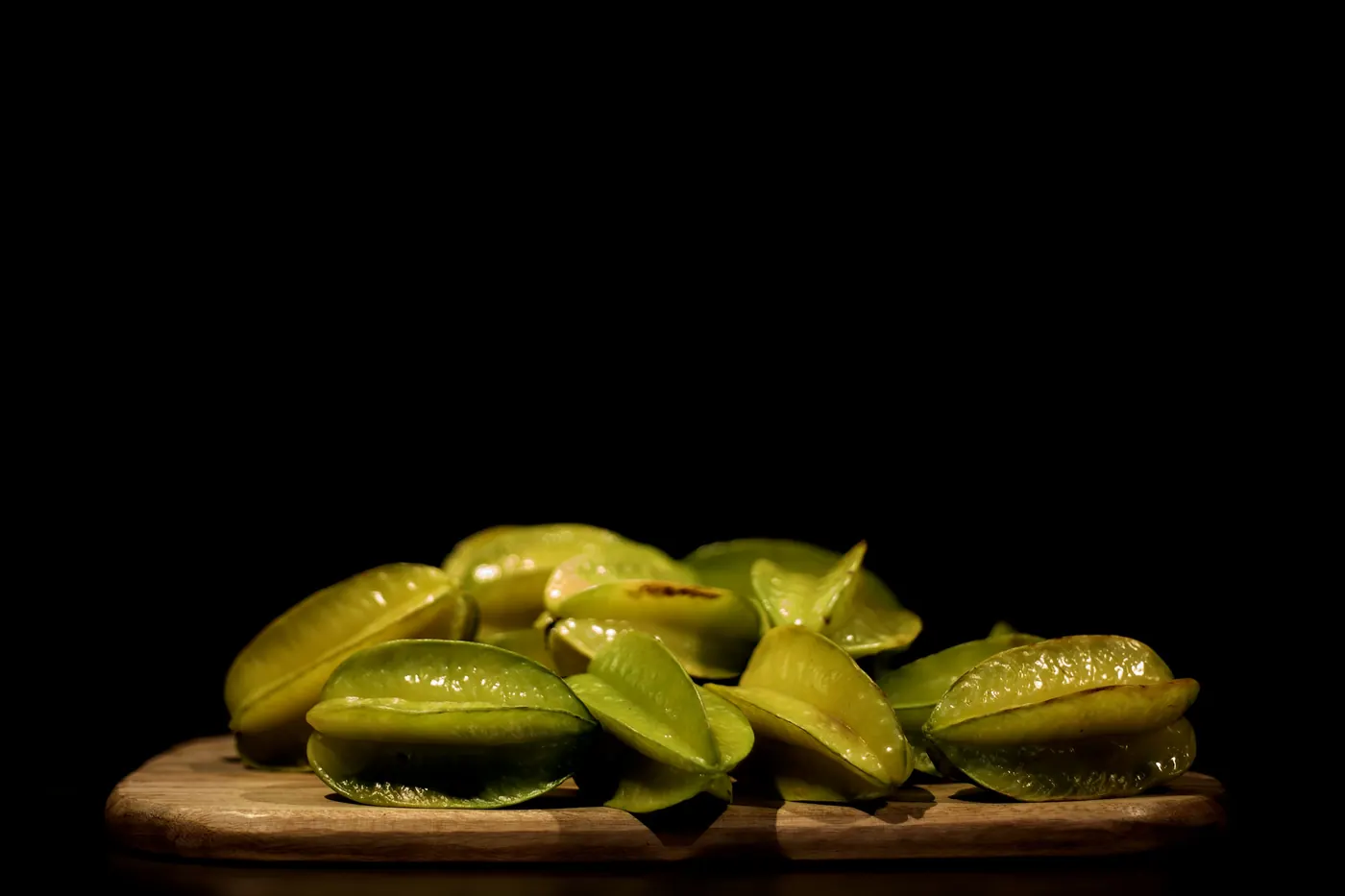 Pickled jalapeno slices on a dark surface