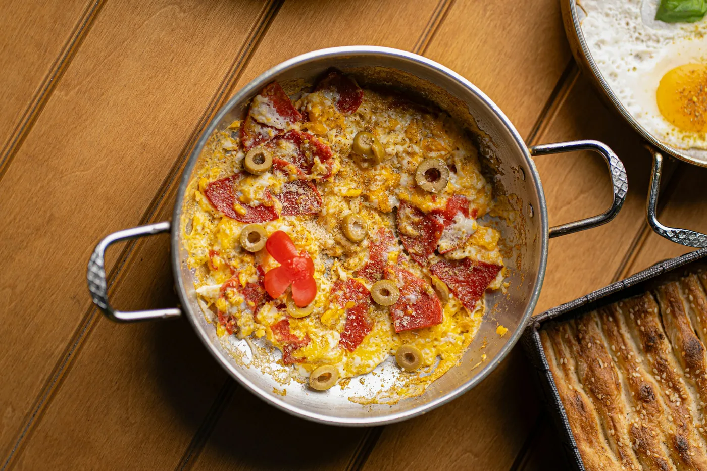 Melted cheese with chorizo bubbling in a shallow metal pan