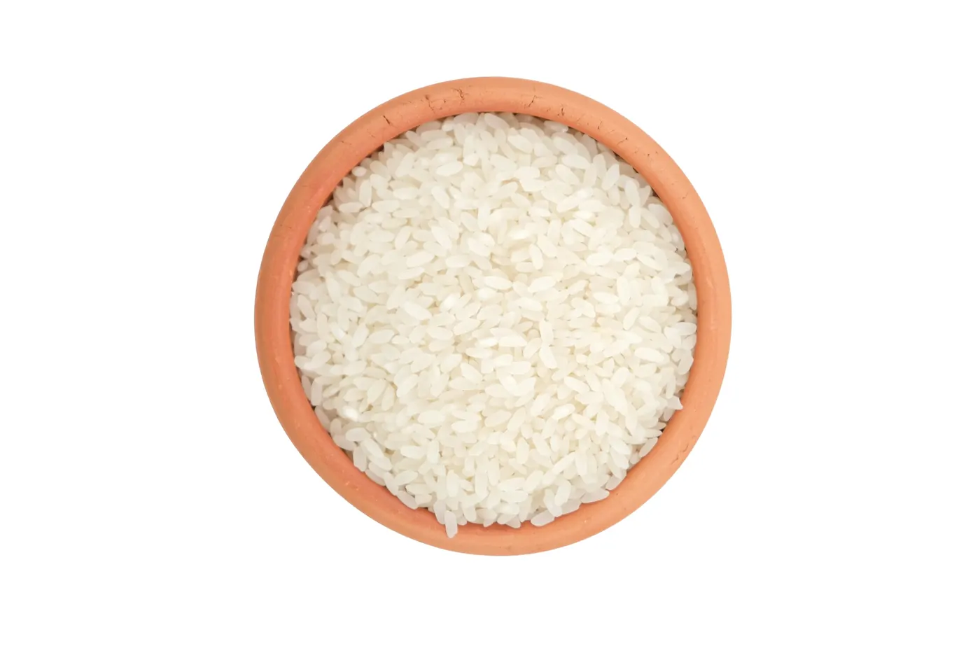 Uncooked white rice grains in a small clay bowl