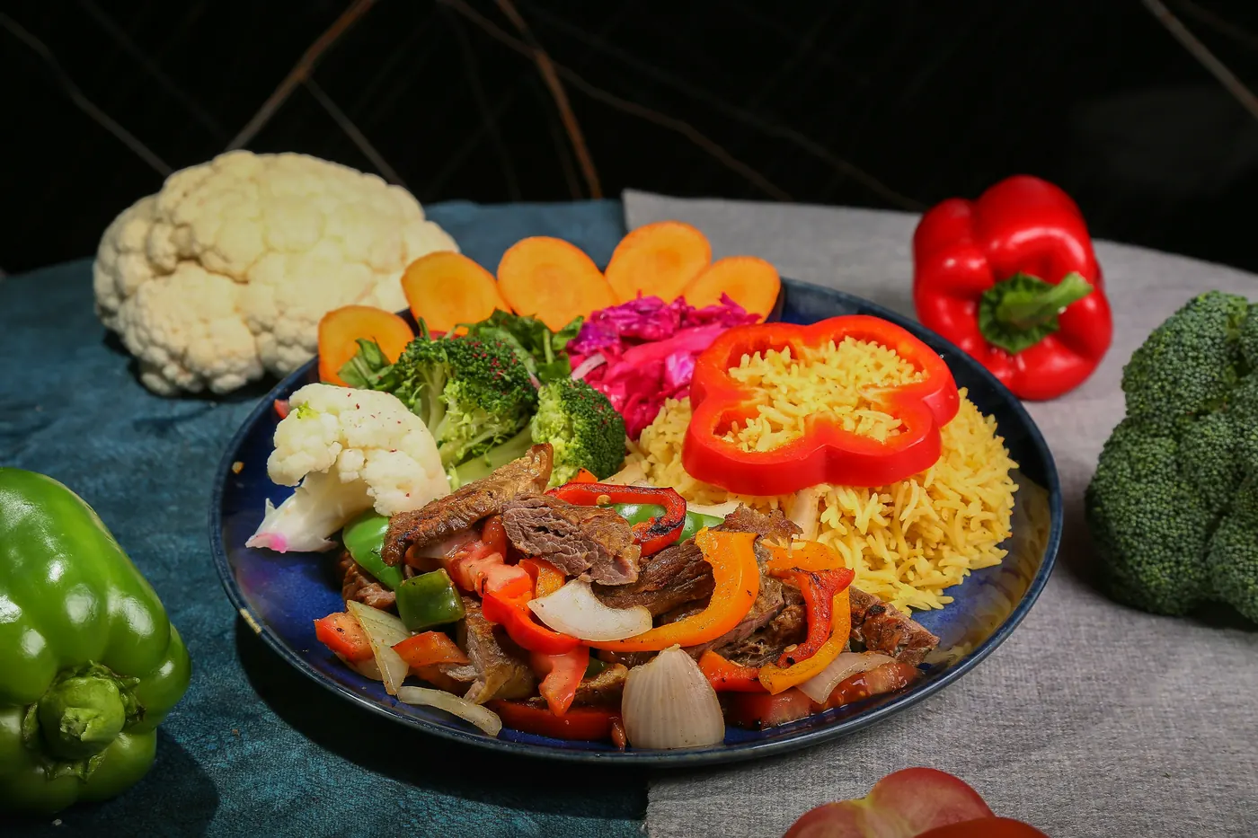 A plate of rice with peppers and mixed vegetables