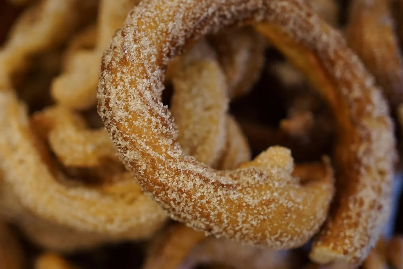 Ring-shaped churros coated in cinnamon sugar