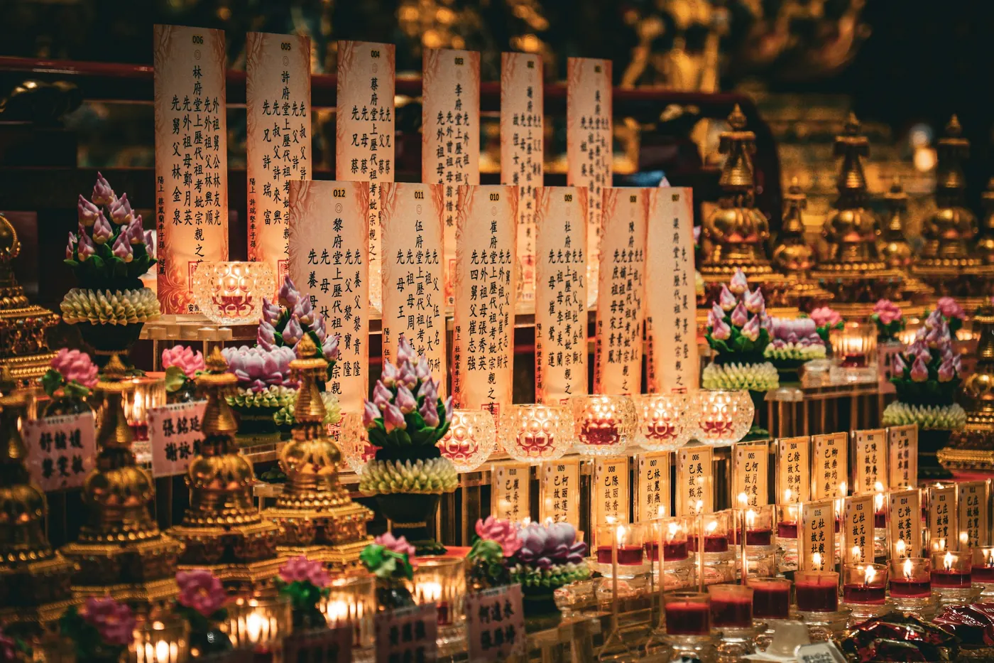 Long rows of candles burning in the dark