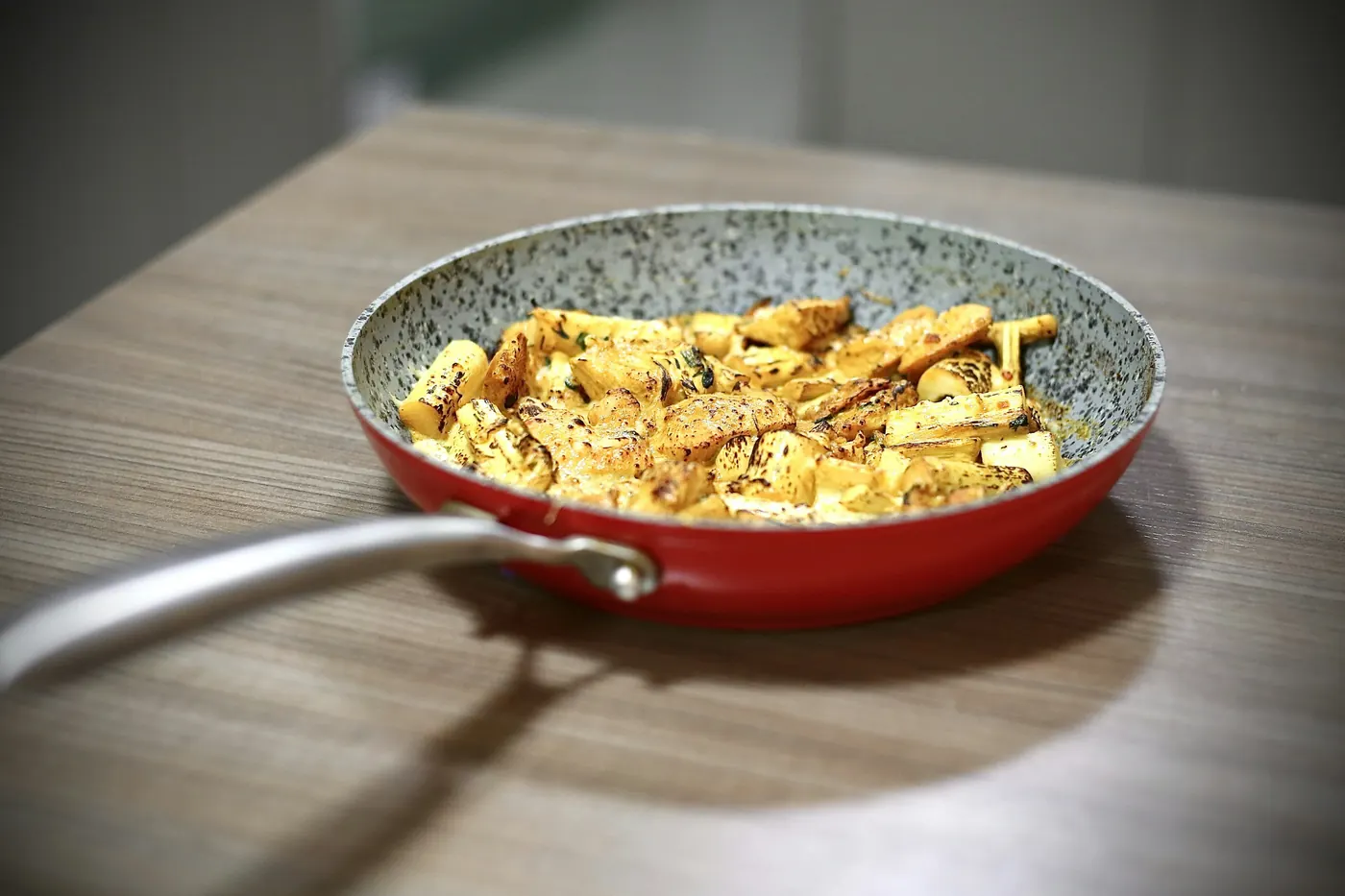 Scrambled eggs with peppers cooking in a shallow pan