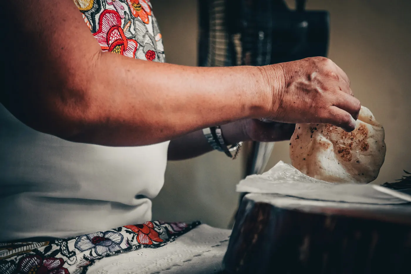 Hands shaping a tortilla on a worktop