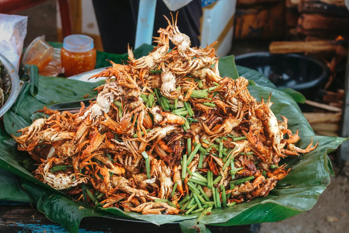 Shredded pork piled on a large green leaf at a market stall
